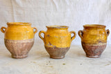 Collection of three very small antique French confit pots with ochre glaze