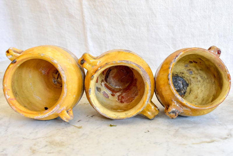 Collection of three very small antique French confit pots with ochre glaze