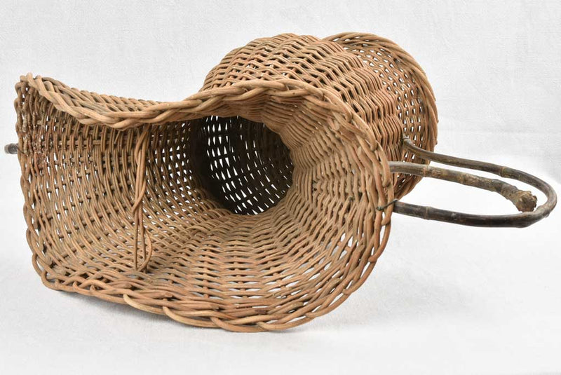 Aged wicker basket with artistic handles