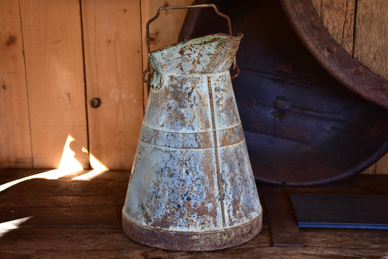 Antique French watering can with aqua patina