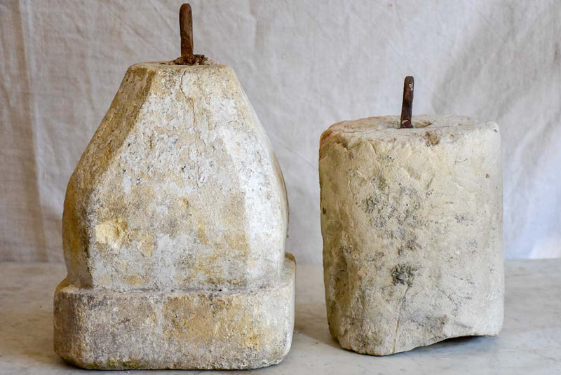 Two antique French stone counterweights