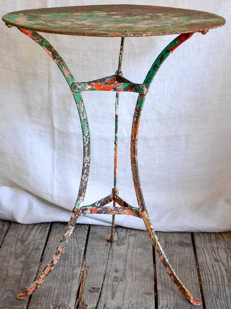 Rustic French garden table with weathered green and orange patina