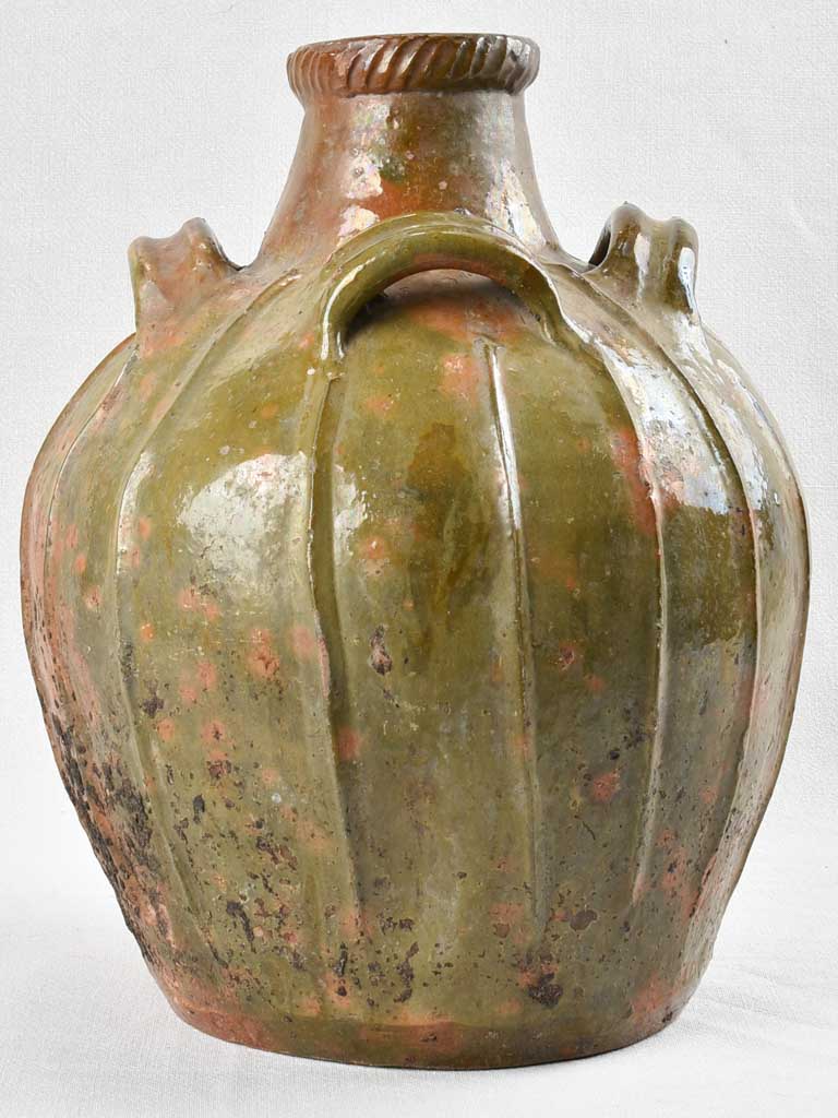 Antique French walnut oil jar with green patina 17¼"