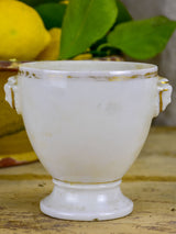Antique French earthenware cup with face handles and gold trim