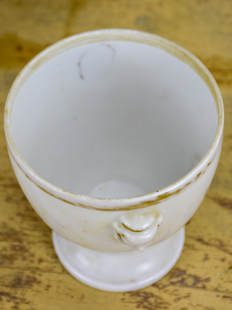 Antique French earthenware cup with face handles and gold trim