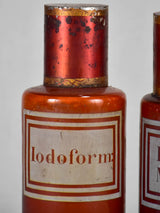 Two late nineteenth-century French apothecary jars with red tin lids 8¼"