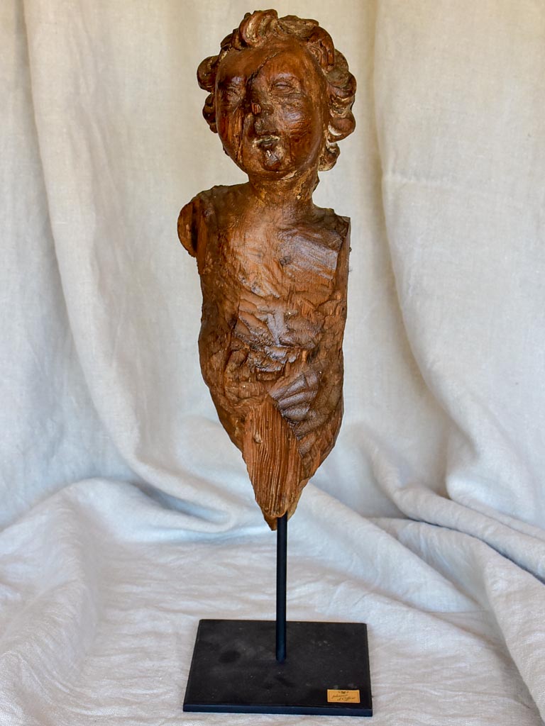 18th Century sculpture of a cherub mounted on an iron stand