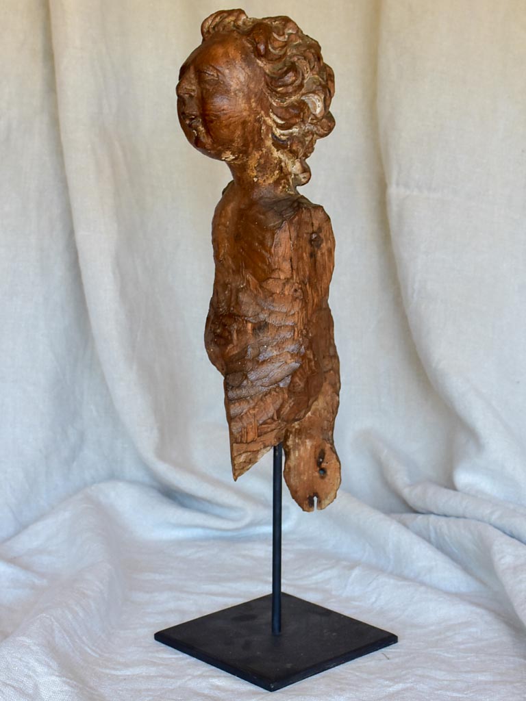 18th Century sculpture of a cherub mounted on an iron stand