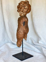 18th Century sculpture of a cherub mounted on an iron stand