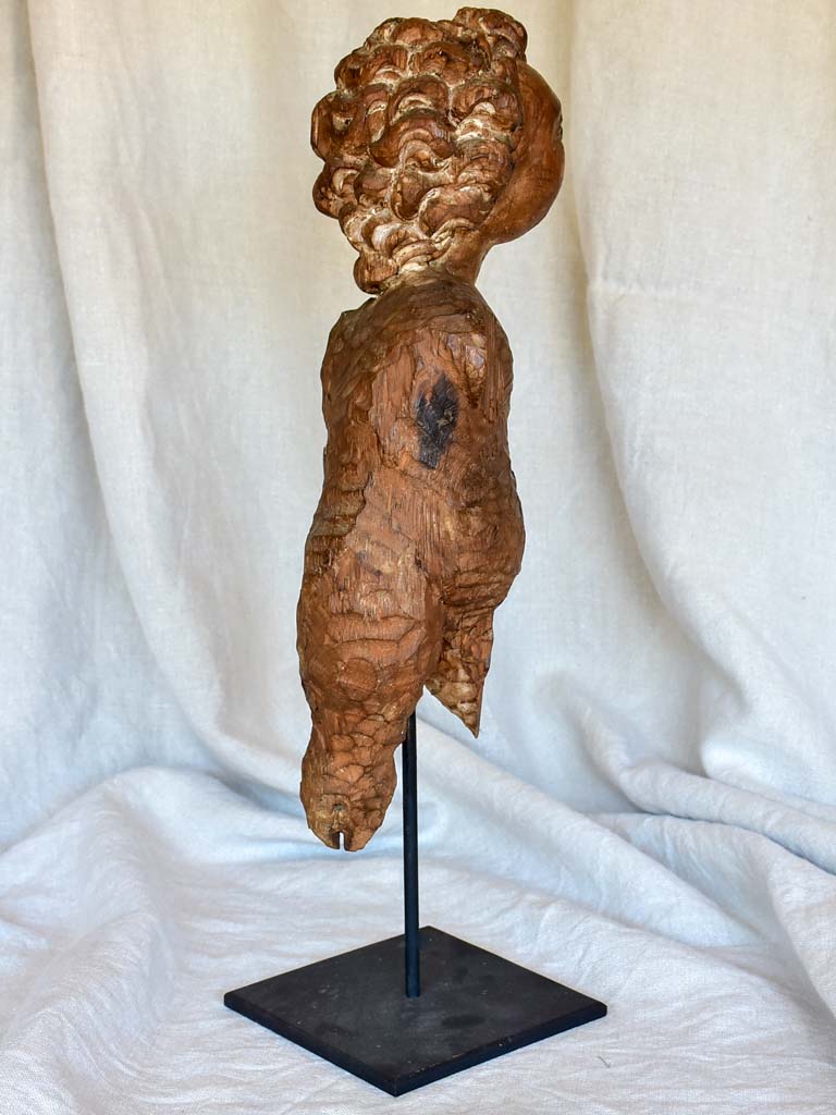 18th Century sculpture of a cherub mounted on an iron stand