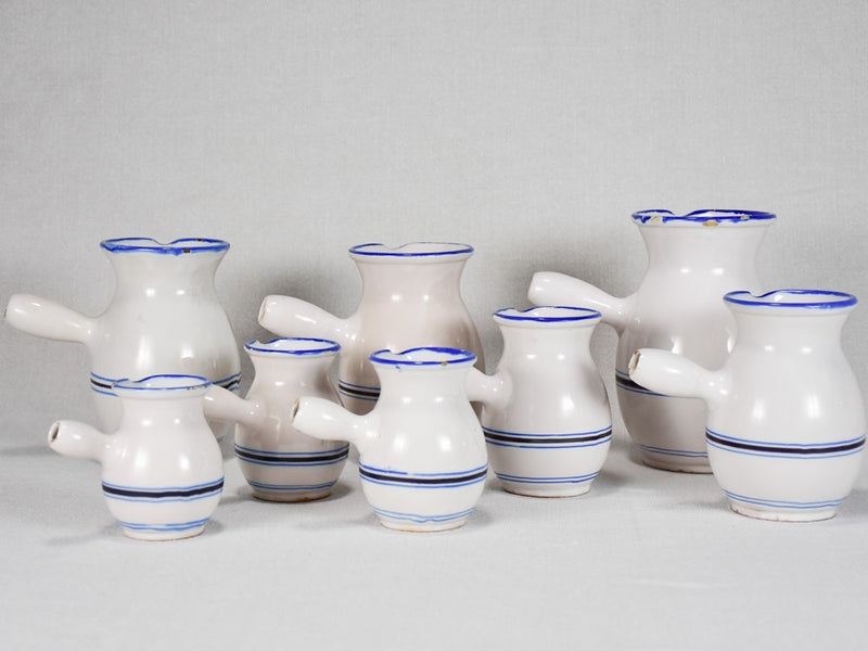 Collection of eight 19th-century white pots with blue stripes from Sète