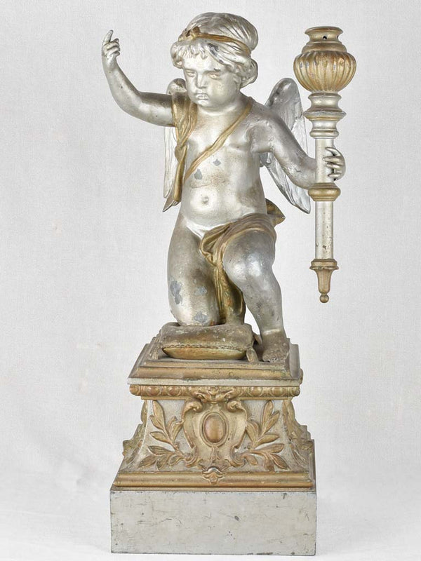Rustic wear cherub holding torch sculpture