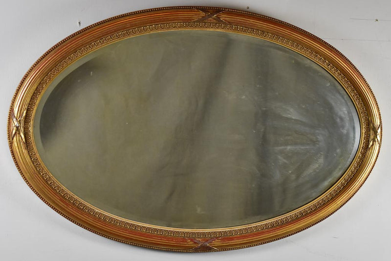 Early twentieth-century oval French mirror with bronzed glass 34¼" x 21¾"