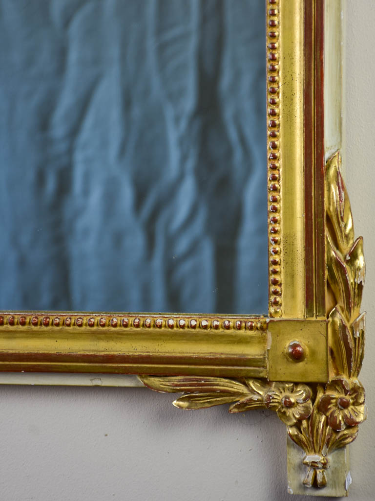 Louis XVI-style gilded mirror with musical floral crest and motifs 26½" x 46¾"