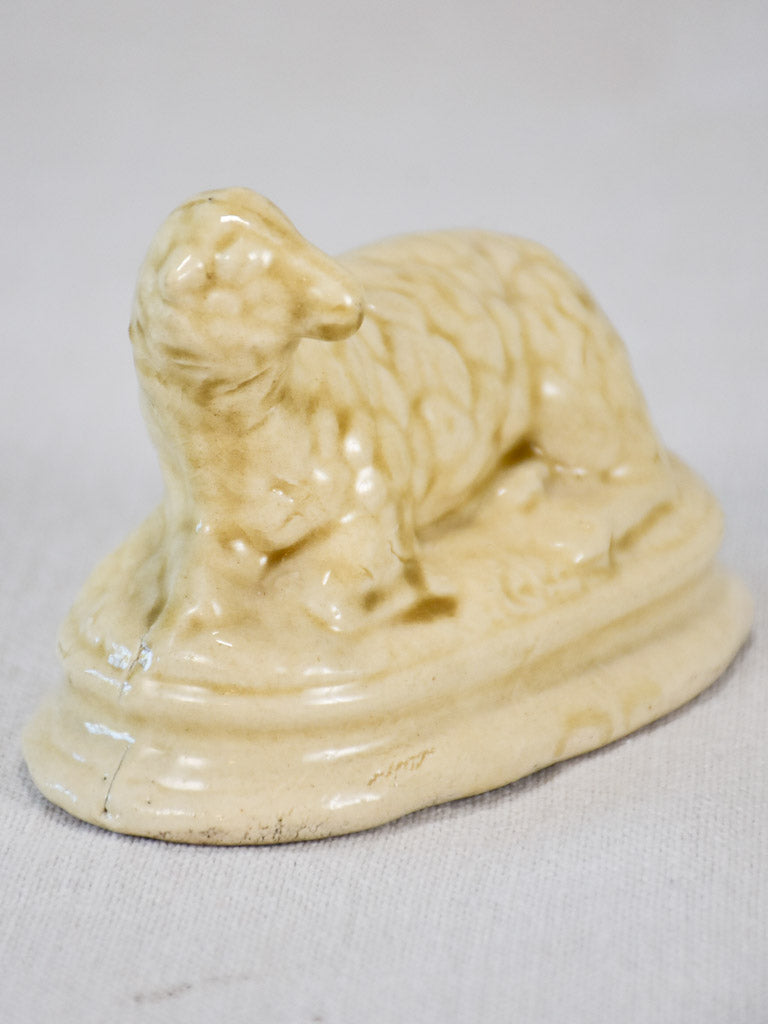 Antique earthenware sheep-themed coin bank