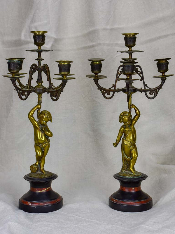 Pair of Napoleon III candlesticks with cherubs