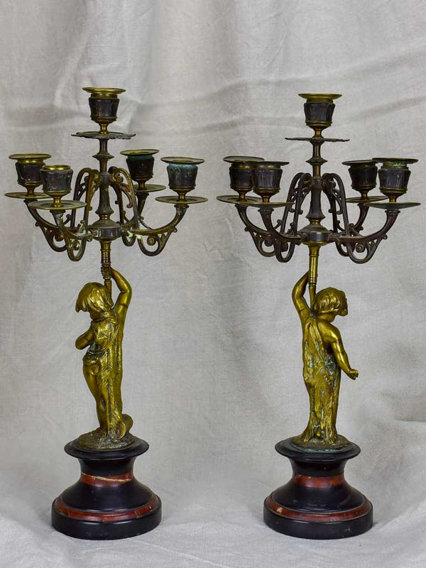 Pair of Napoleon III candlesticks with cherubs