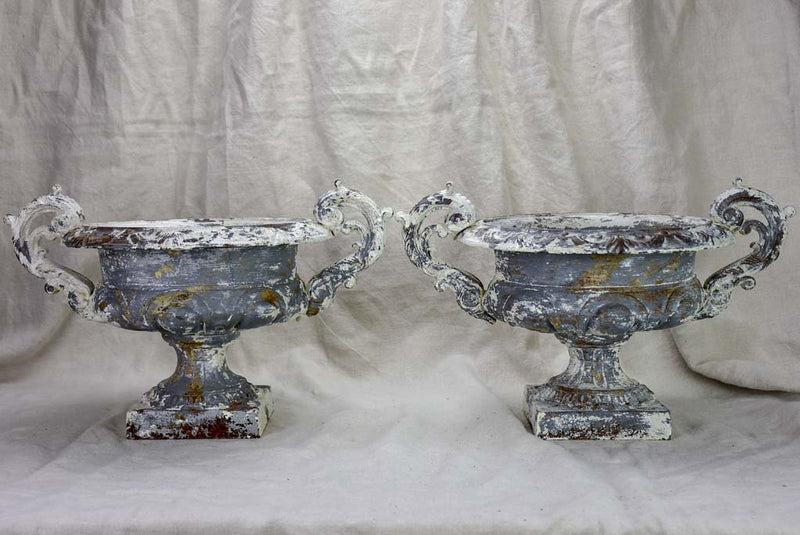 Pair of antique French Medici urns with large handles and white patina