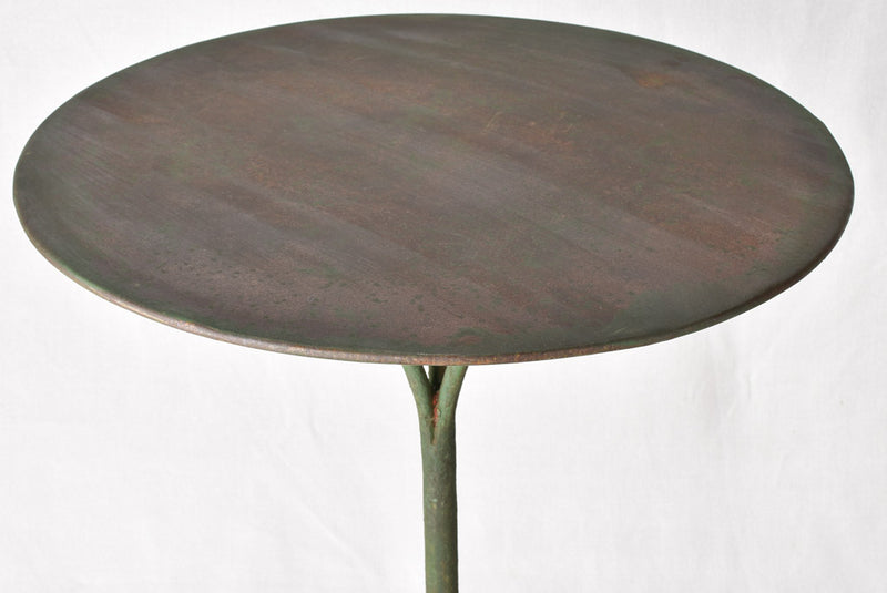 Claw foot round garden table with green patina