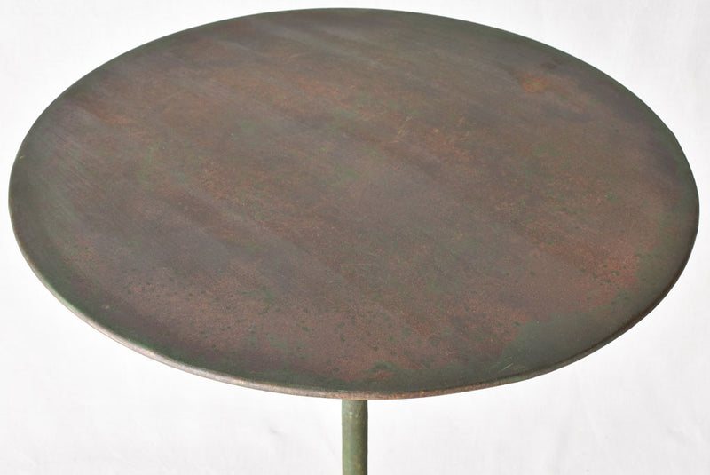 Claw foot round garden table with green patina