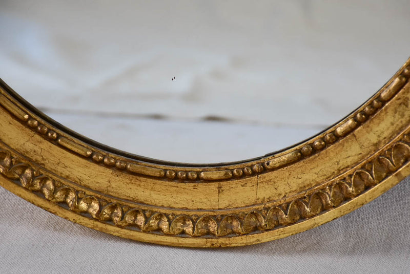 Louis XVI style oval mirror with large bow pediment 20¾" x 28¾"