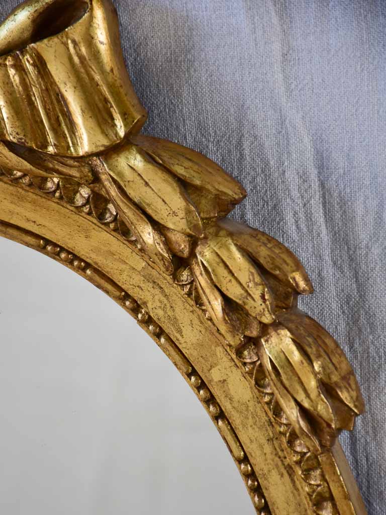 Louis XVI style oval mirror with large bow pediment 20¾" x 28¾"