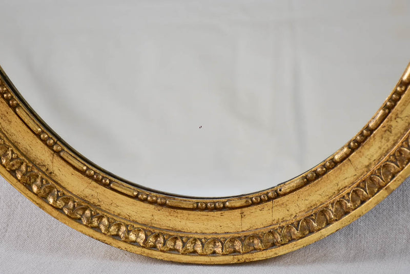 Louis XVI style oval mirror with large bow pediment 20¾" x 28¾"