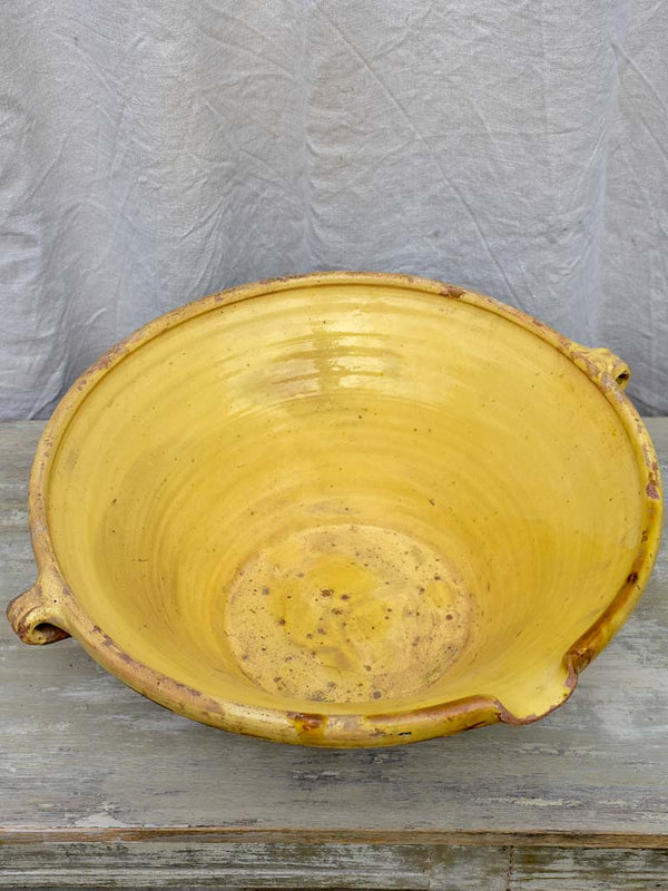 Large antique French tian bowl with yellow glaze, two handles and beak - 20¾ diameter"