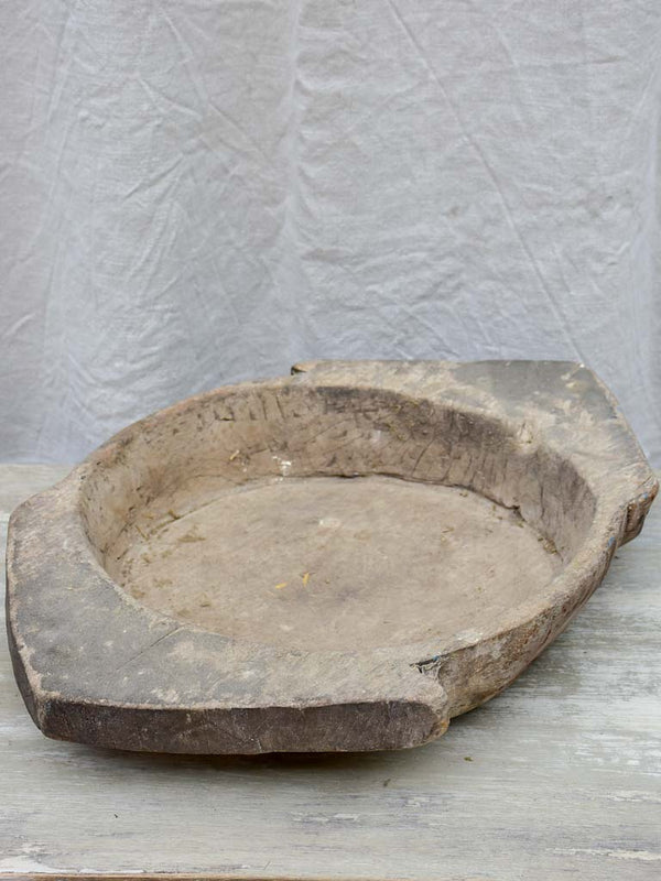 Primitive wooden dish with pointed handles