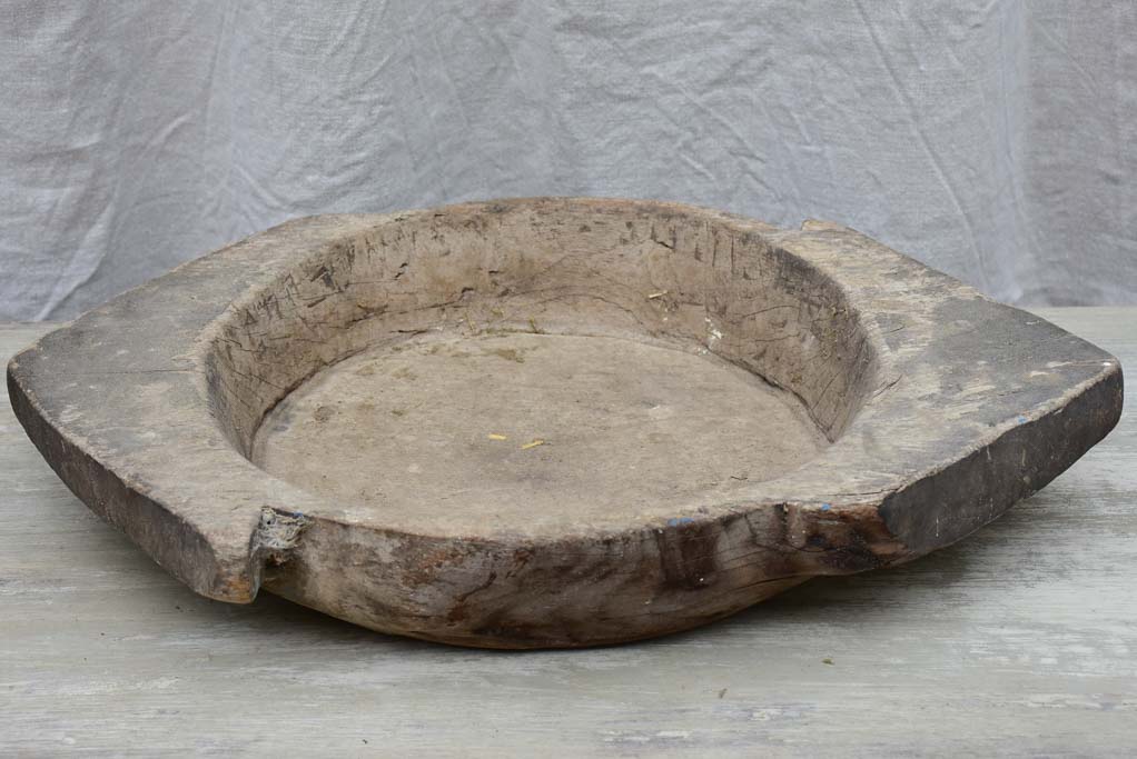 Primitive wooden dish with pointed handles