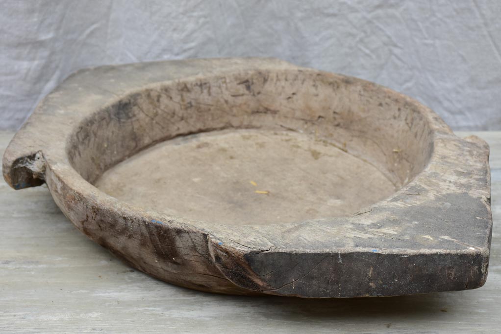 Primitive wooden dish with pointed handles