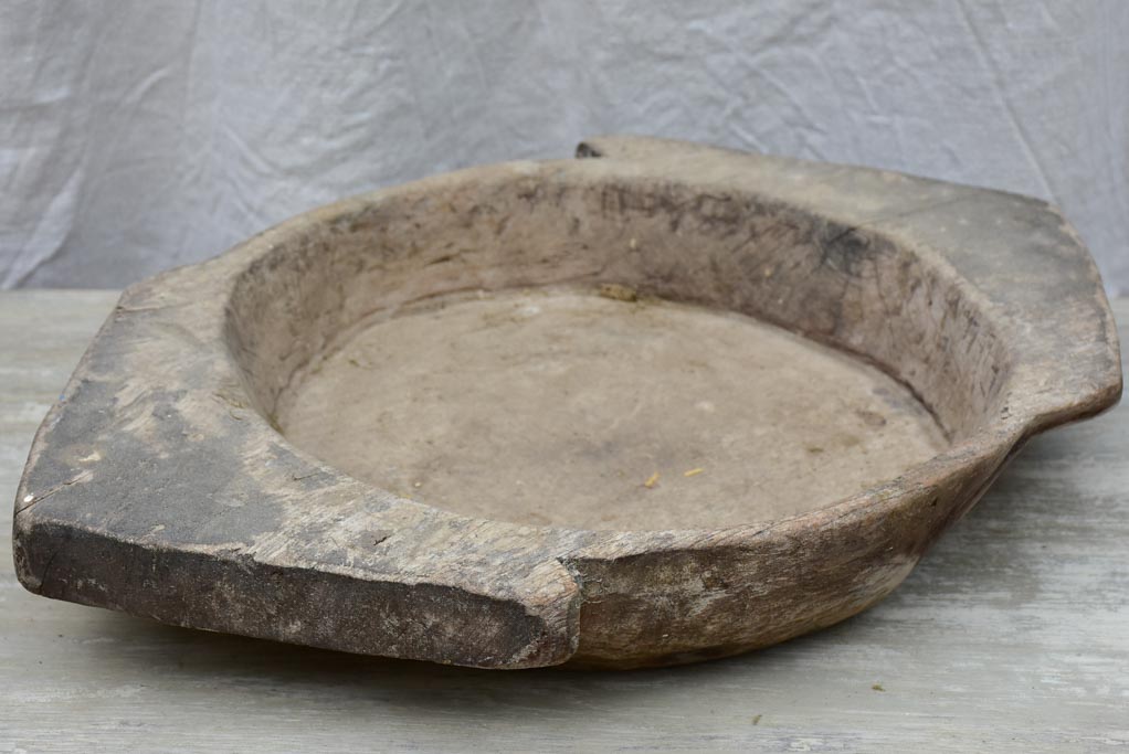 Primitive wooden dish with pointed handles