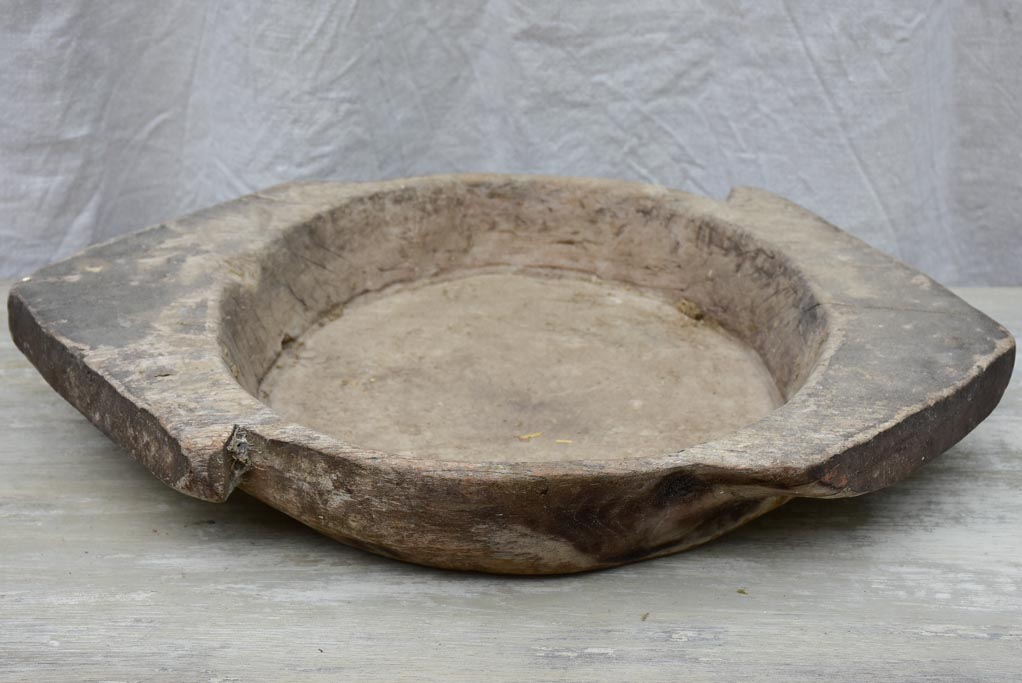 Primitive wooden dish with pointed handles