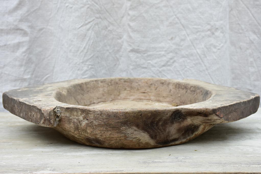 Primitive wooden dish with pointed handles