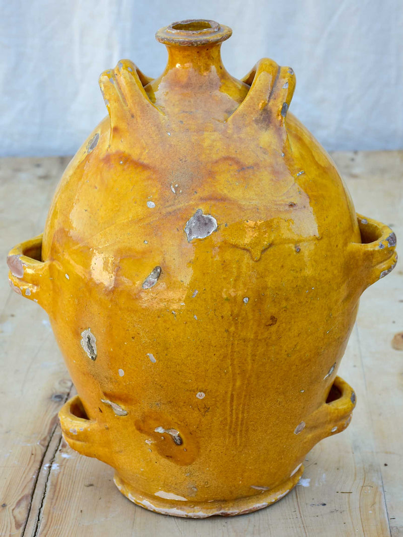 Antique French conscience water jug with yellow glaze