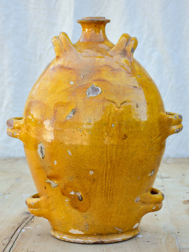 Antique French conscience water jug with yellow glaze