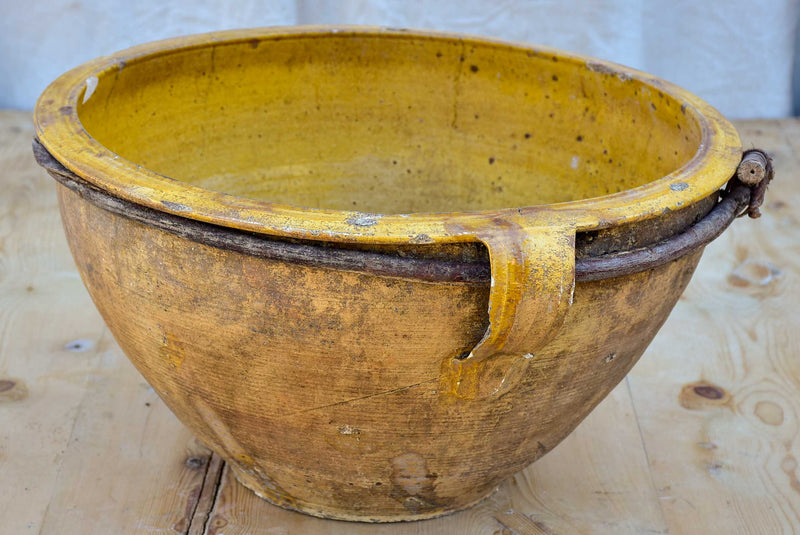 Large antique terracotta bowl with yellow glaze
