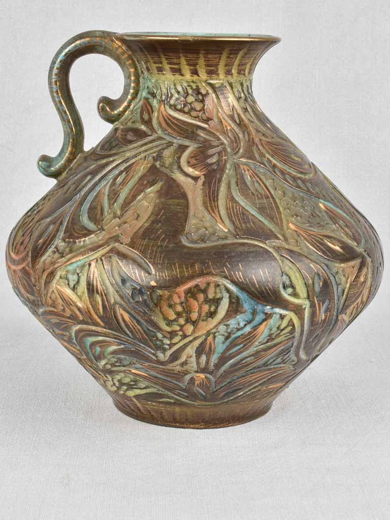 Retro pottery pitcher with floral carvings