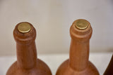 Collection of five wooden sculptures in the shape of bottles
