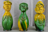 Three antique folk art pitchers with yellow and green glaze
