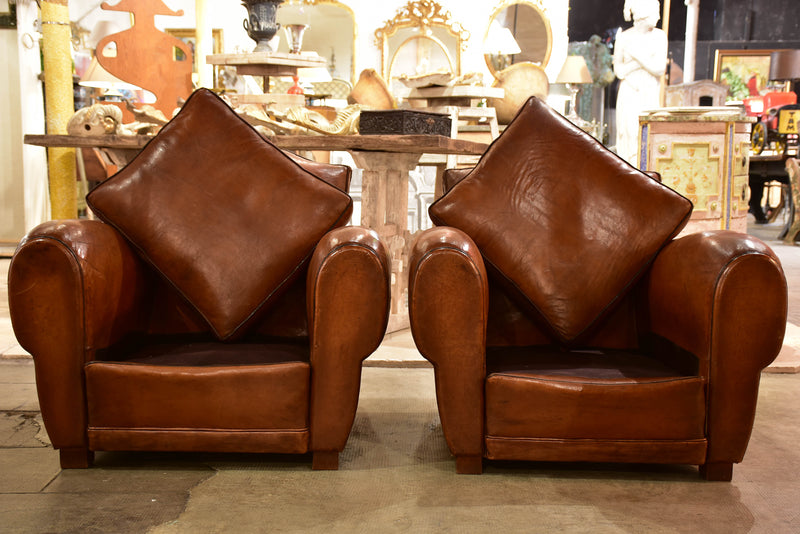 Pair of large moustache back French leather club chairs