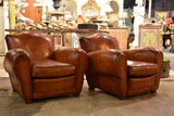 Pair of large moustache back French leather club chairs
