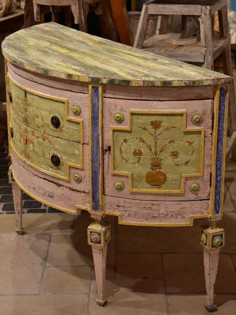 Demilune commode with pink, green, yellow and blue patina