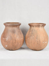 Pair of large oil jars with brown patina