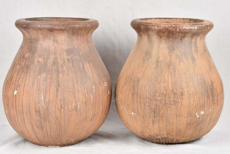 Pair of large oil jars with brown patina
