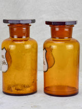 Two amber glass antique French apothecary jars with octagonal lids