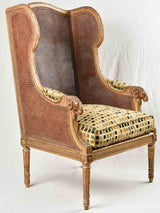 Large cane bergere armchair - ram's heads - 19th century
