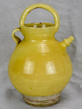 Antique French water pitcher with pale yellow glaze