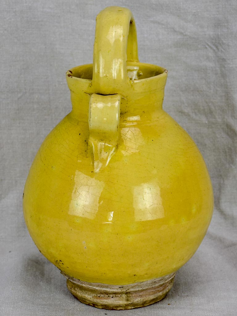 Antique French water pitcher with pale yellow glaze