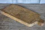 Large antique French cutting board with rounded handle and shoulders